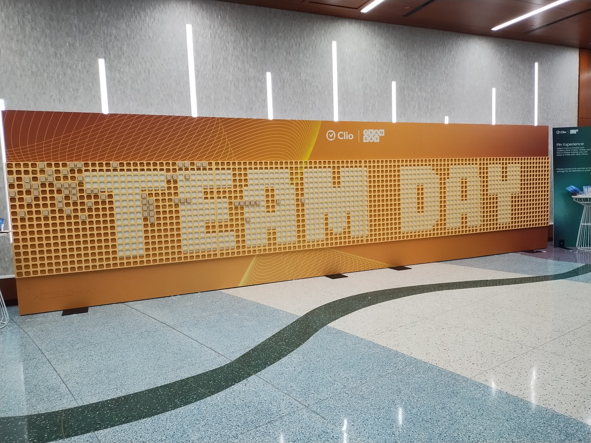 Clio Team Day branded check-in wall with TEAM DAY graphic