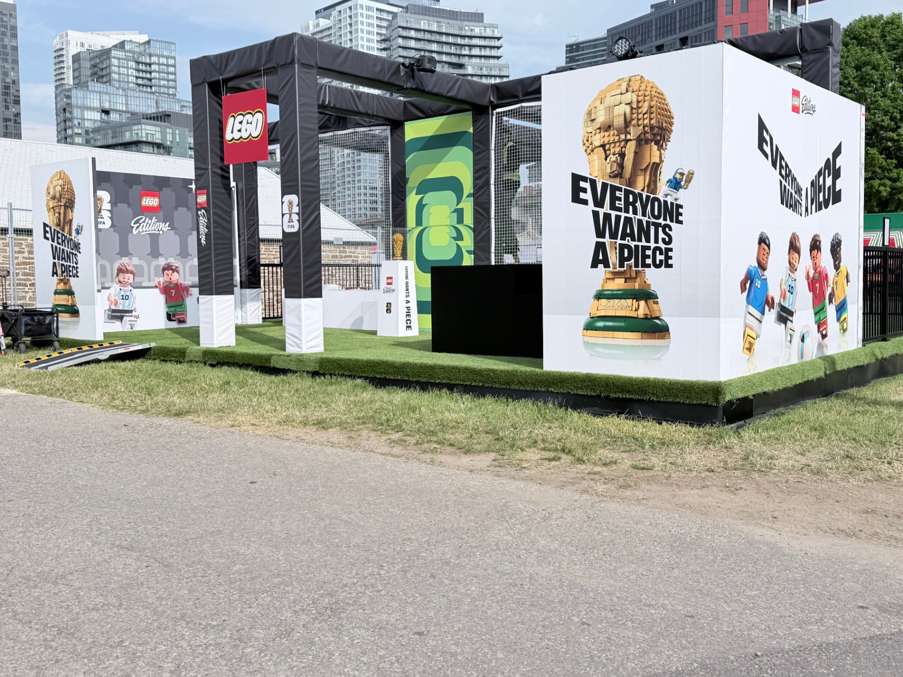 Wide view of the LEGO Editions FIFA World Cup 26 activation with inflatable gantry, LEGO flag, and hero graphic cube