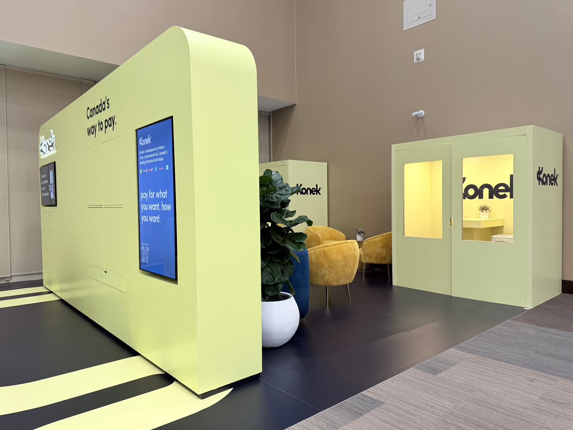 Curved Konek hero wall with 'pay for what you want, how you want' messaging and adjacent private lounge entrance