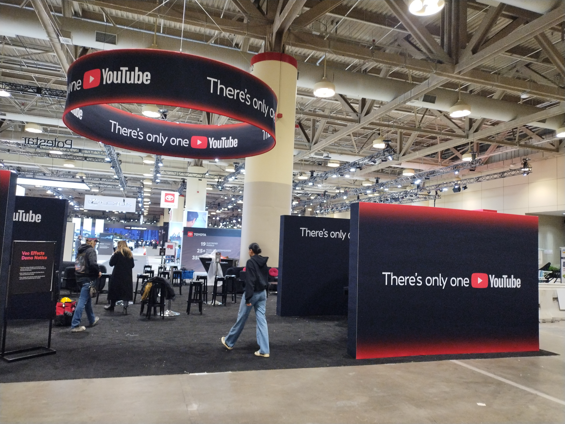 YouTube branded feature wall with red gradient and overhead ring
