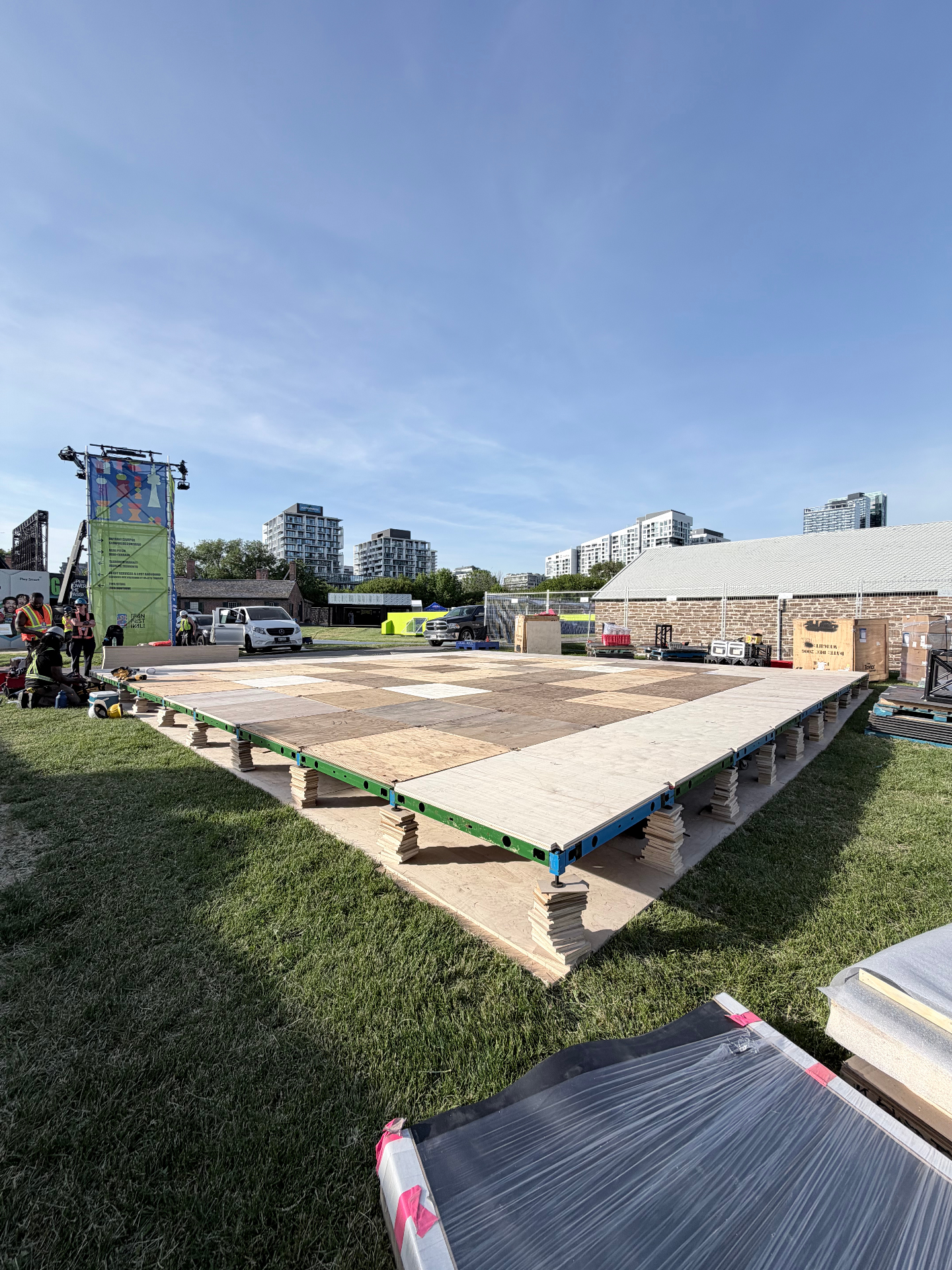 Raw plywood pitch platform on stacked supports before turf installation for the LEGO Editions FIFA activation