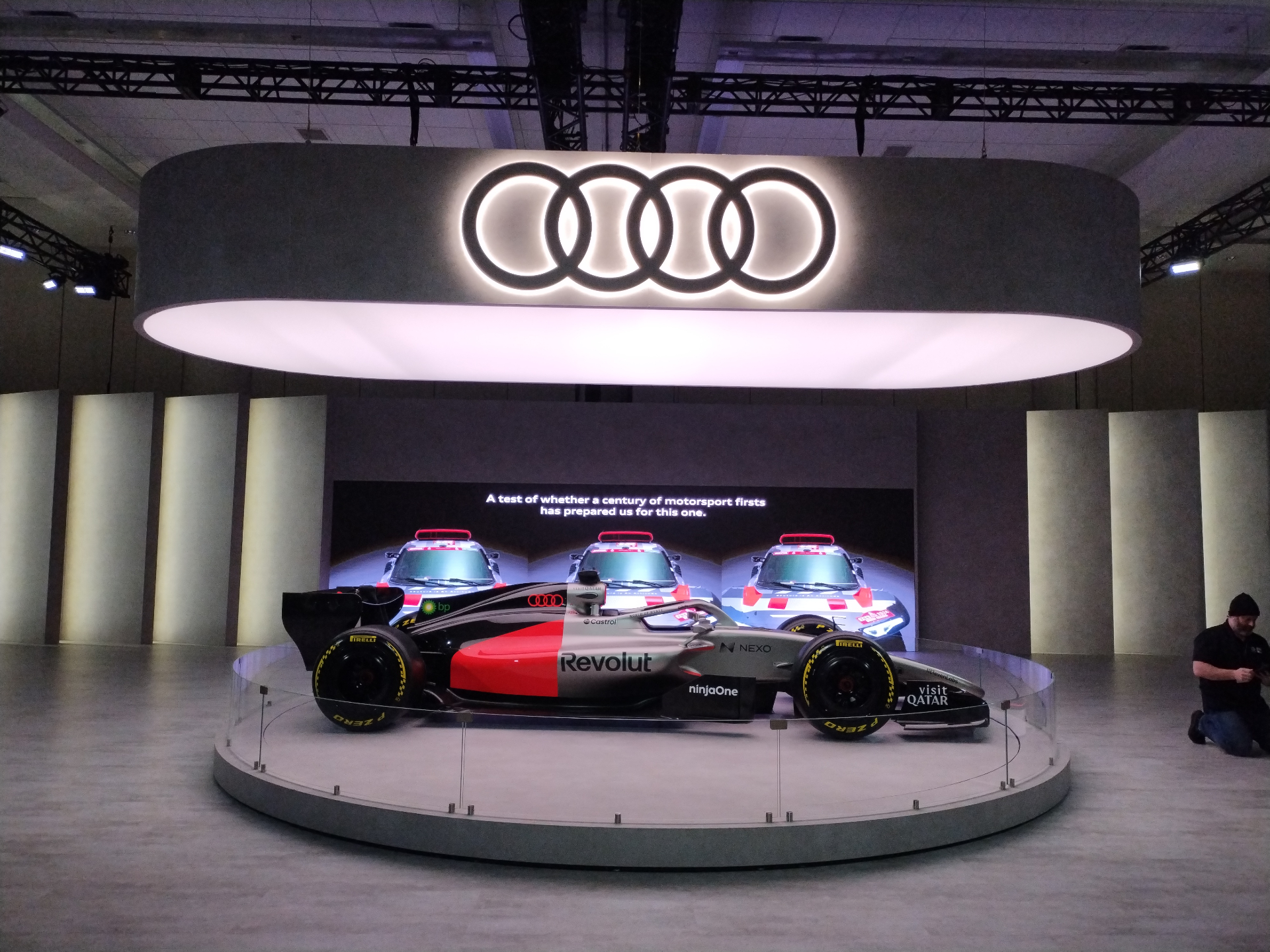 Audi Haus F1 hero car under illuminated overhead ring at the Toronto Auto Show