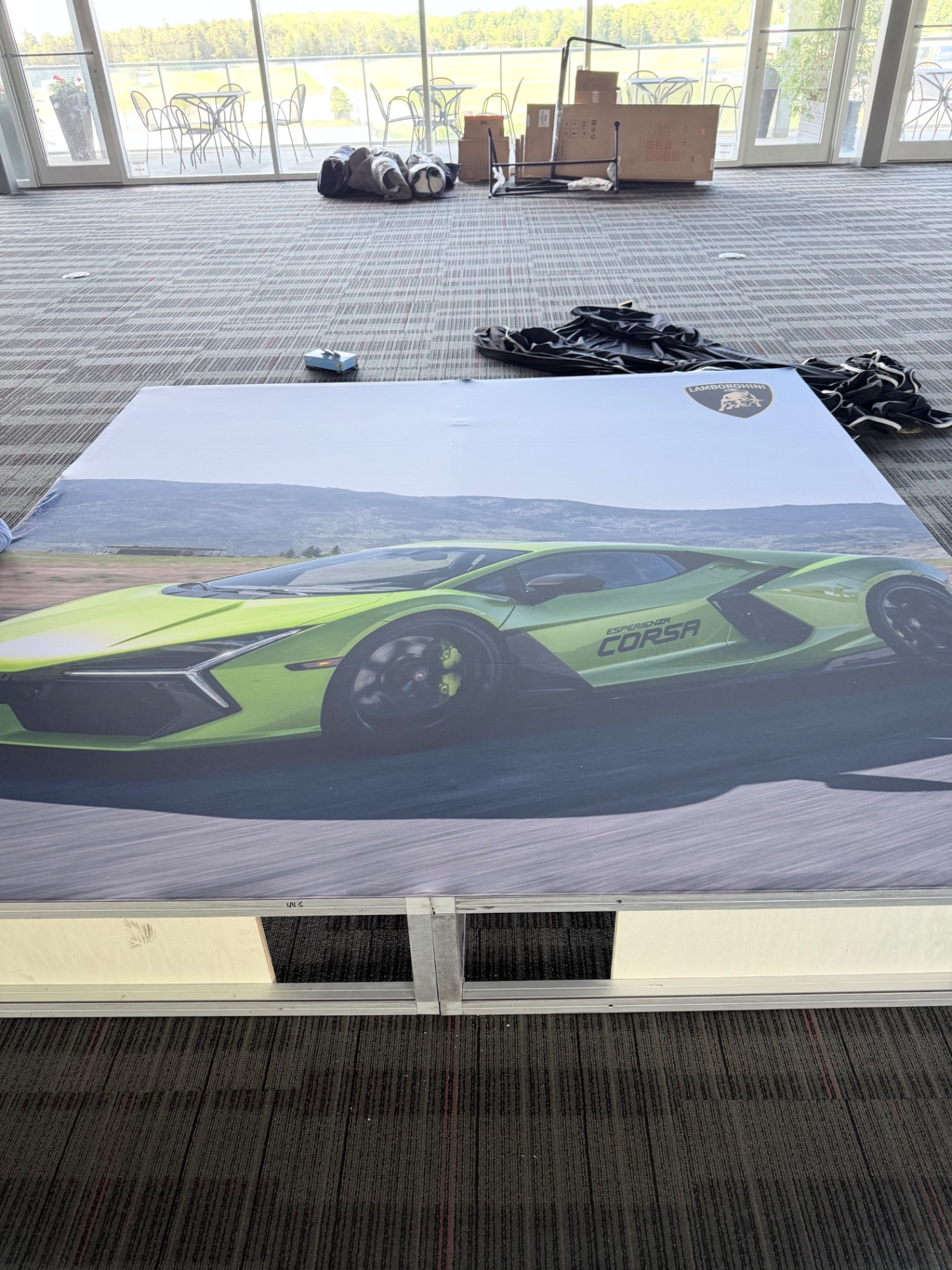 Lamborghini Revuelto photo wall laid out on raised platform during install at Canadian Tire Motorsport Park