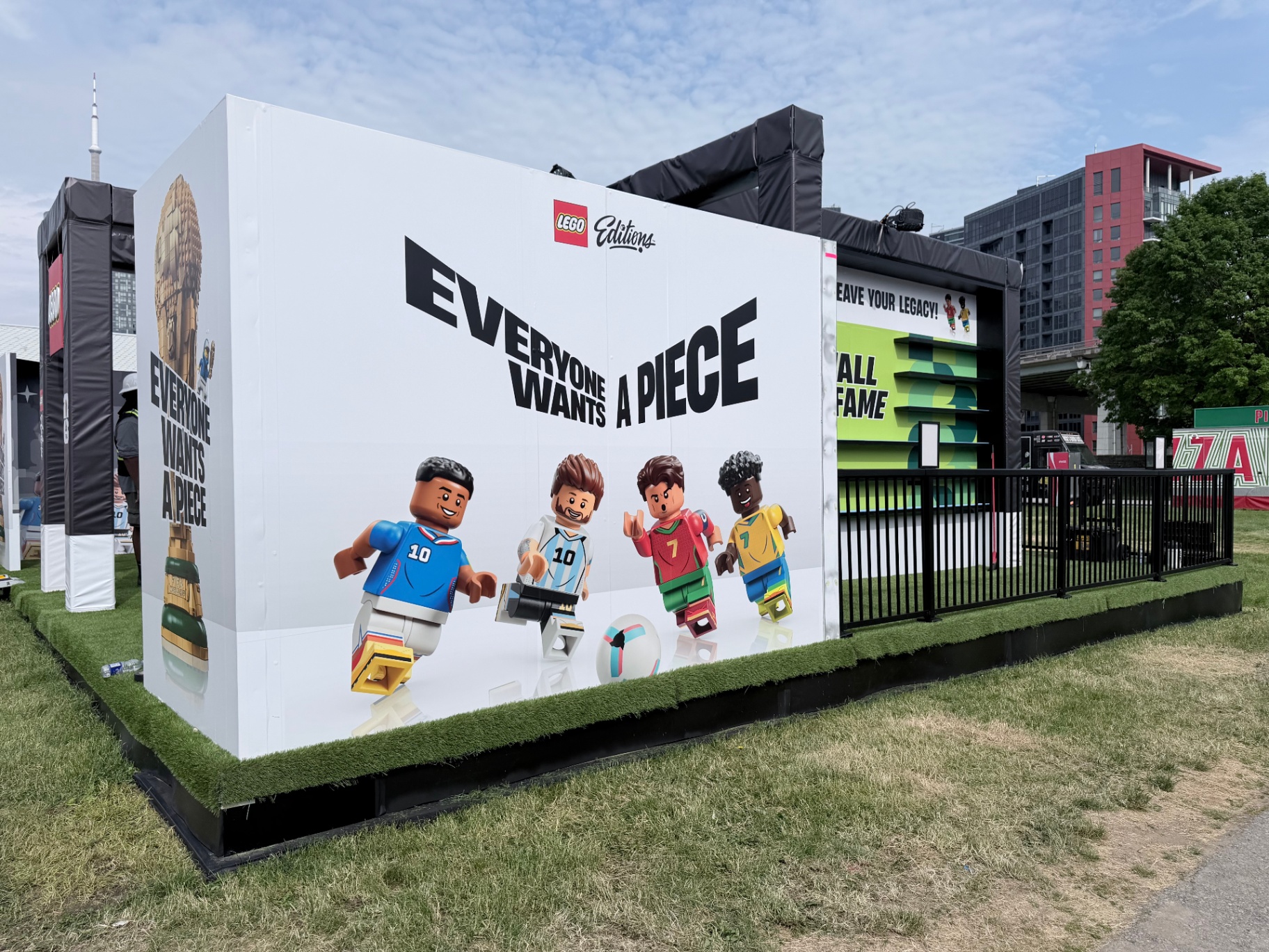 LEGO Editions 'Everyone Wants A Piece' hero graphic cube with FIFA World Cup 26 minifigure players on a turf base