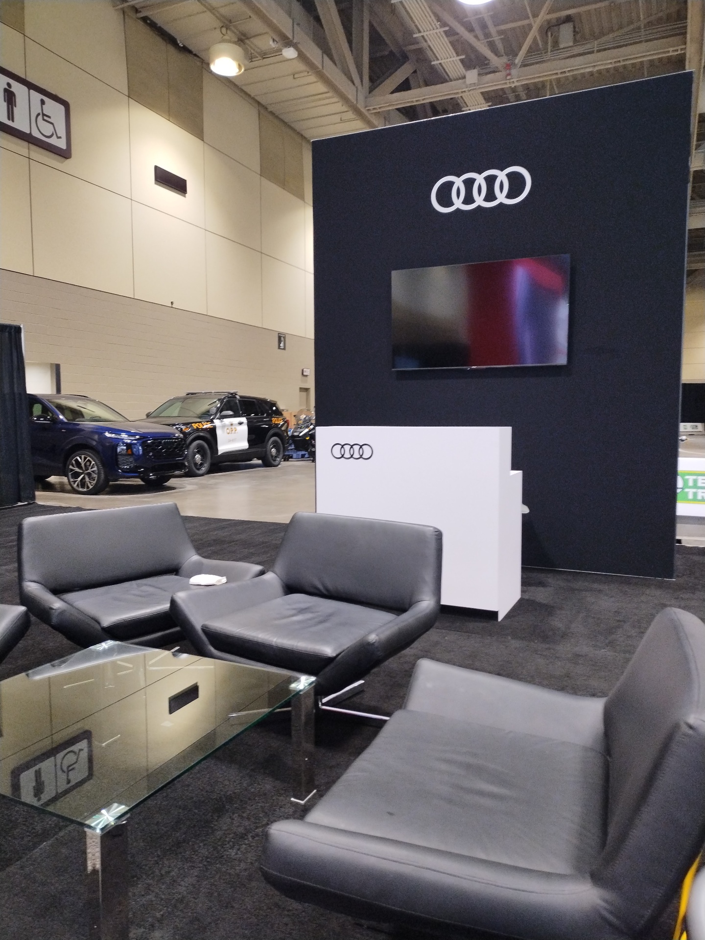 Audi Haus private lounge with backlit rings and hospitality counter
