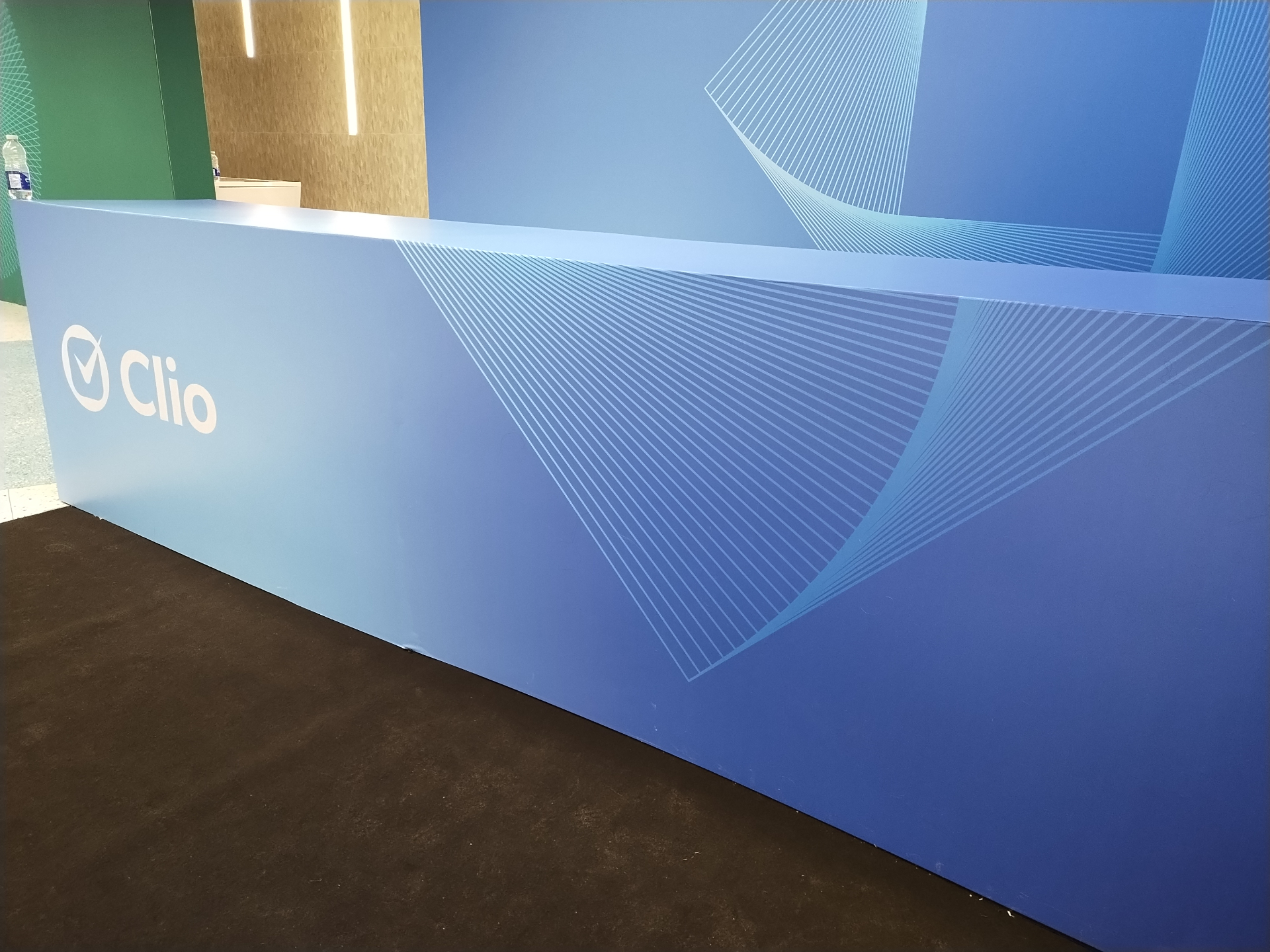 Clio branded counter installation with geometric linework