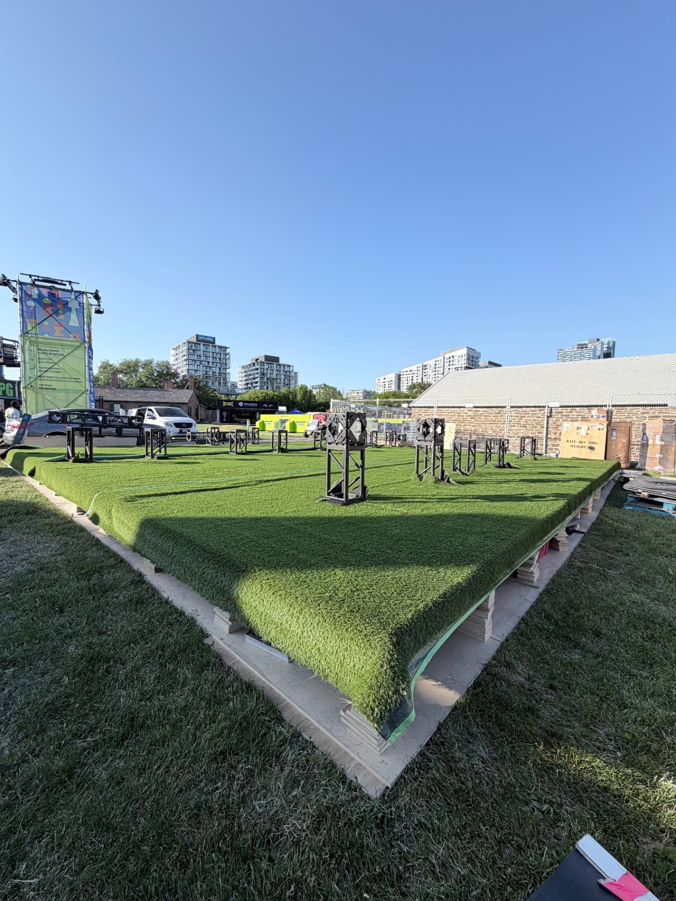 Edge of the custom-built elevated turf pitch showing plywood substructure and branded training towers