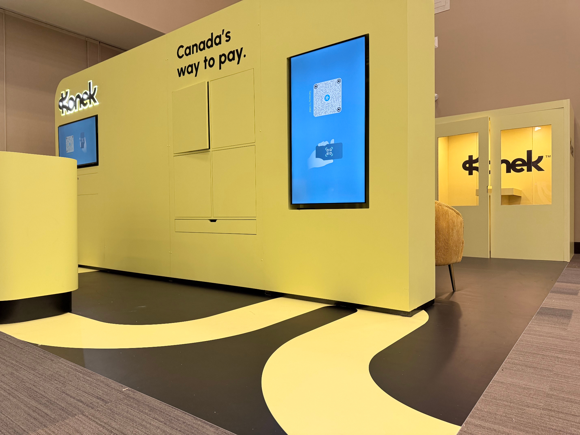 Konek chartreuse product wall with illuminated logo, vertical screens, and 'Canada's way to pay' headline